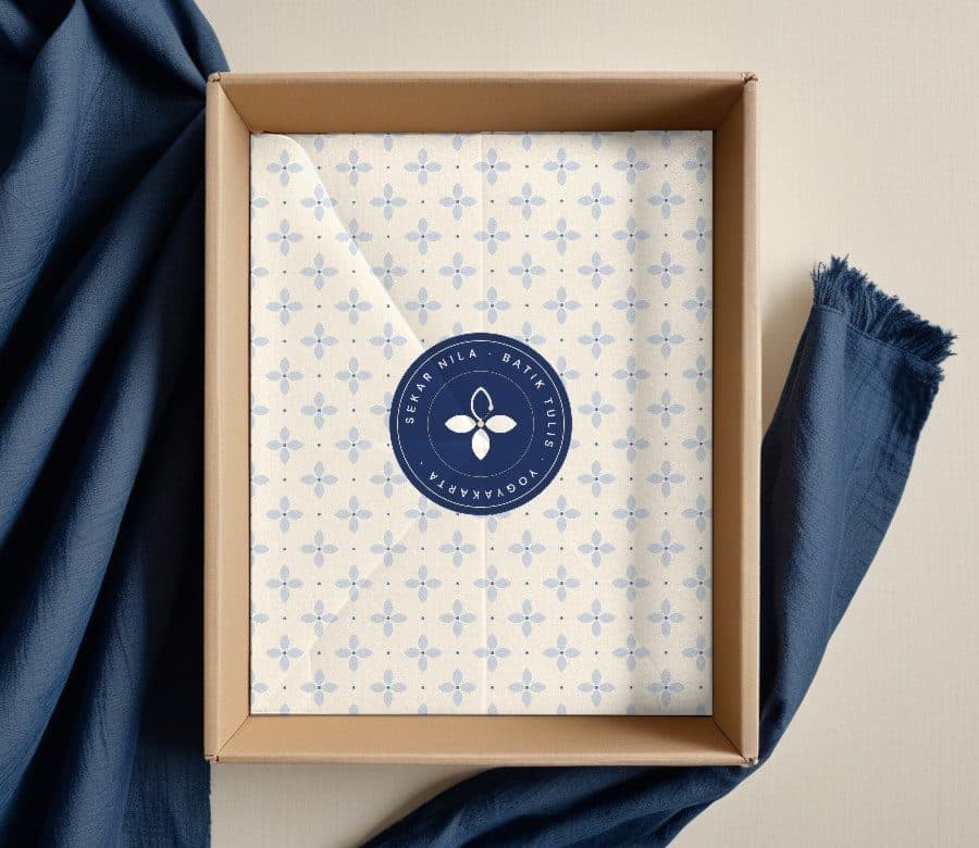 Open box with ceplok tissue paper closed by a round seal
